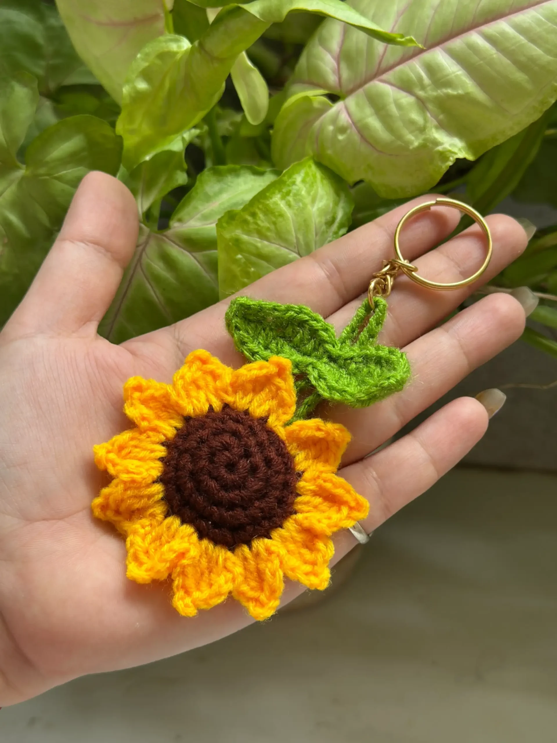 Handmade crochet sunflower keychain with green leaf for gifting