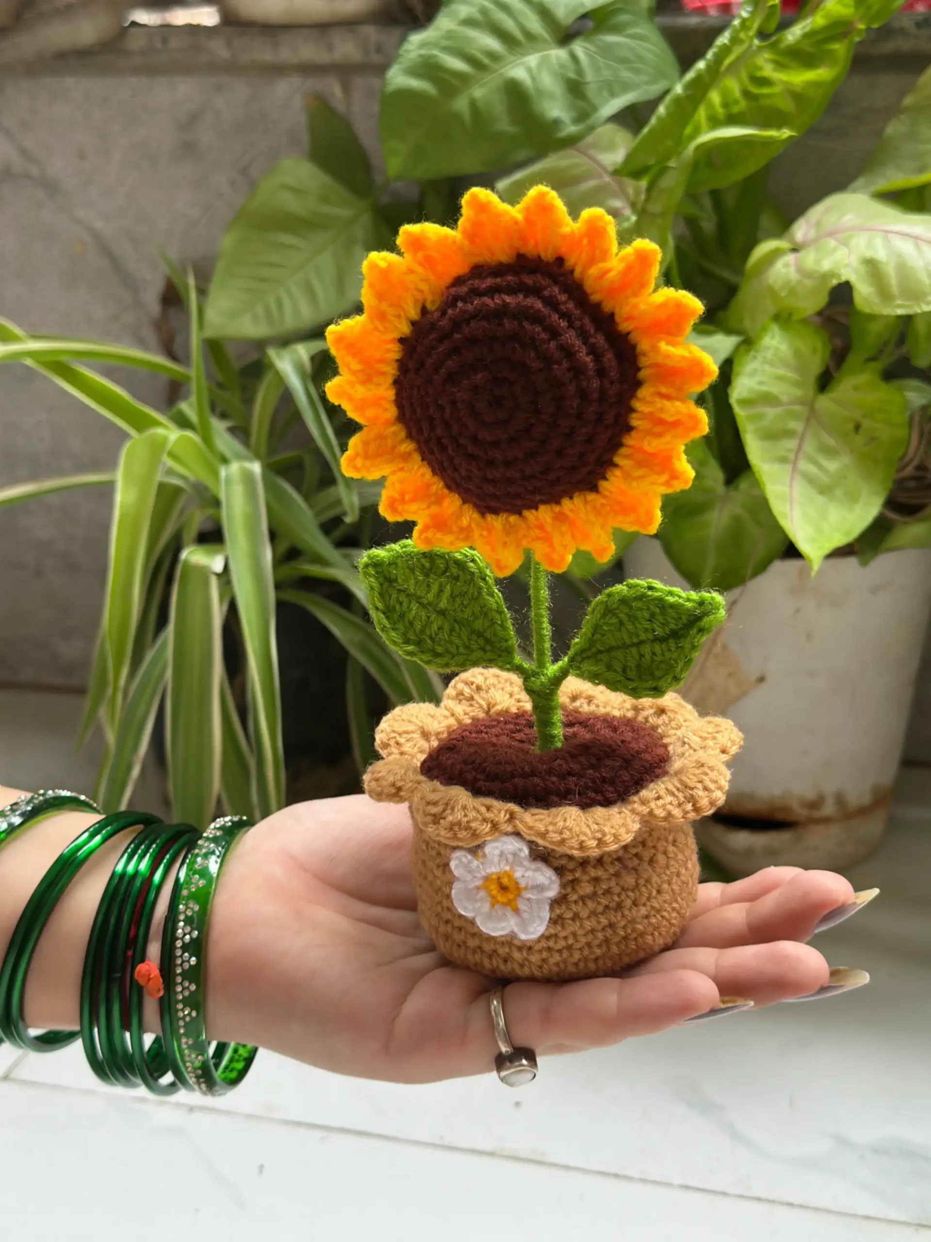 Handmade crochet sunflower plant in brown pot