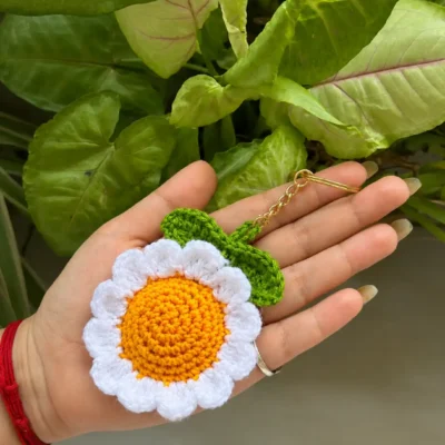 Handmade white crochet daisy flower keychain with yellow center